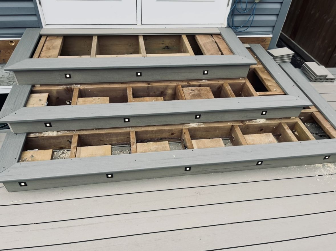 Composite deck stairs with recessed LED step lights installed in each riser