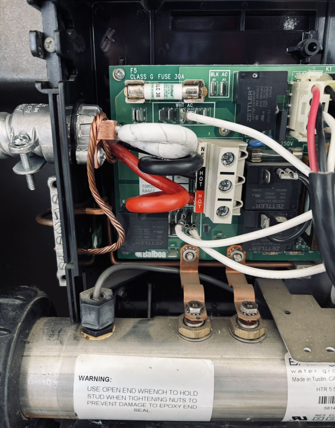Hot tub control pack wired with neatly formed conductors and a bonded ground