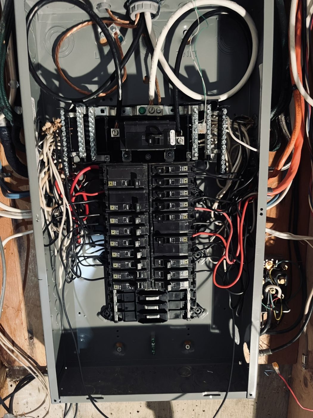 Open 100 amp residential panel showing breakers and wiring